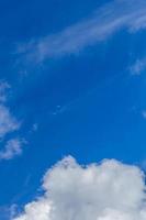 Regular spring clouds on blue sky at daylight in continental europe. Close shot wit telehoto lens and polarizing filter. photo