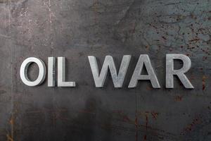 words oil war laid in line with silver metal letters on rusted heavy hot rolled uncoated steel sheet surface in linear perspective photo