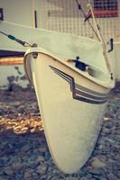 Detail of a catamaran on the beach. Vertical image. photo