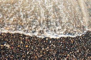 Sea shore with round stones on the mediterranean coast. Horizontal image. photo