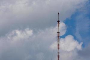 tall metal frame television tower on cloudy sky daylight background photo