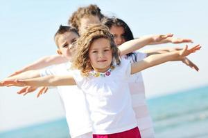 happy child group playing  on beach photo