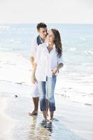 happy young couple have fun at beautiful beach photo