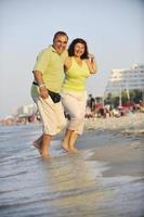 happy seniors couple  on beach photo