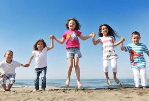 happy young  people group have fun on beach photo