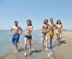 happy people group have fun and running on beach photo