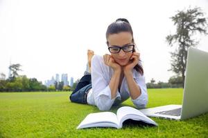 woman with laptop in park photo