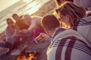 Friends having fun at beach on autumn day photo