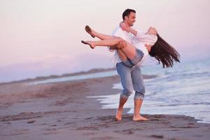 pareja joven en la playa divertirse foto