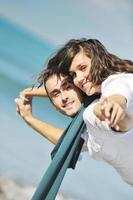 happy young couple have fun at beautiful beach photo