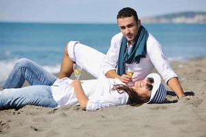 young couple enjoying  picnic on the beach photo