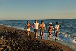 people group running on the beach photo