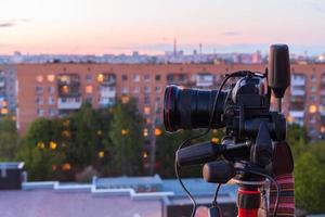 pro dslr on tripod in evening roof photoshoot photo