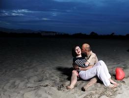 happy young couple have fun on beach photo