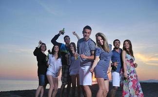 Group of young people enjoy summer  party at the beach photo