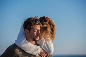 couple having fun at beach during autumn photo