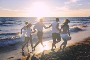 people group running on the beach photo