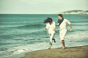 happy young couple have fun at beautiful beach photo