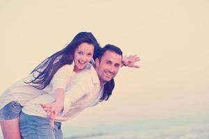 young couple  on beach have fun photo