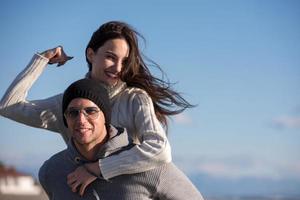 couple having fun at beach during autumn photo