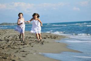 cute little girls running on beach photo