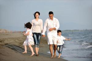 happy young family have fun on beach photo