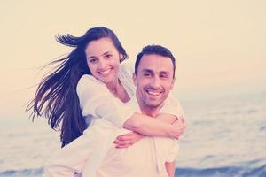 young couple  on beach have fun photo