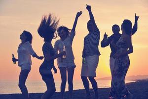 Group of young people enjoy summer  party at the beach photo