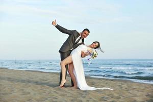 romantic beach wedding at sunset photo