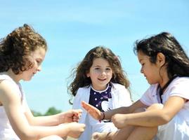 happy child group playing  on beach photo