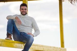 Young man enjoying the warm autumn day photo