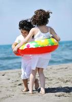 happy child group playing  on beach photo