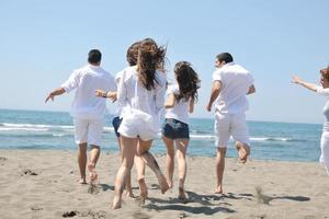 happy people group have fun and running on beach photo