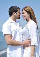 happy young couple have fun on beach photo