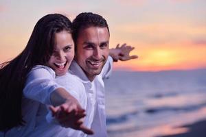 young couple  on beach have fun photo