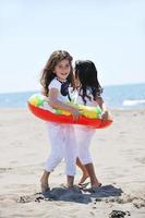 happy child group playing  on beach photo