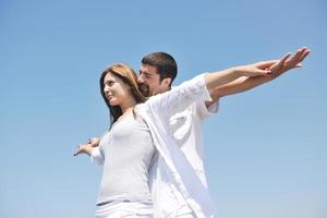 happy young couple have fun on beach photo