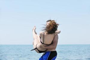 happy young couple have fun on beach photo