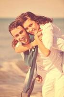 happy young couple have fun at beautiful beach photo