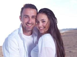 young couple  on beach have fun photo