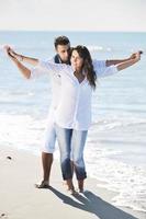 happy young couple have fun at beautiful beach photo