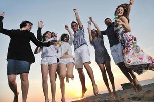 Group of young people enjoy summer  party at the beach photo