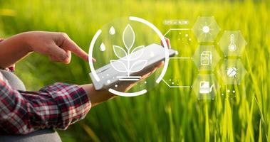 agricultor de tecnología agrícola que tiene tableta digital o tecnología de tableta para investigar sobre datos de análisis de problemas agrícolas e icono visual. granjero agrícola inteligente que usa internet de las cosas foto