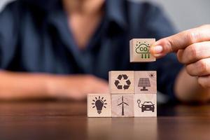 Companies are targeting net zero greenhouse gas emissions. Carbon credit concept.Tradable certificate to drive industry in direction of low emissions in efficiency cost. Wooden cubes with decrease CO2 photo