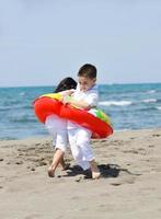 happy young  people group have fun on beach photo