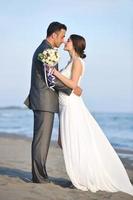 romantic beach wedding at sunset photo