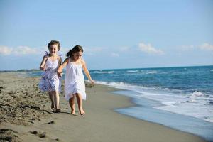 cute little girls running on beach photo