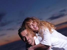 young couple  on beach have fun photo