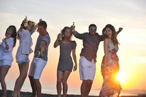 Group of young people enjoy summer  party at the beach photo