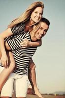 happy young couple have romantic time on beach photo